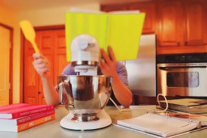 A kid's reading skills improve from from being in the kitchen. They learn different measurements, and to follow steps.