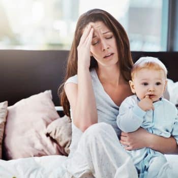 Shot of a stressed mother and her baby boy at home