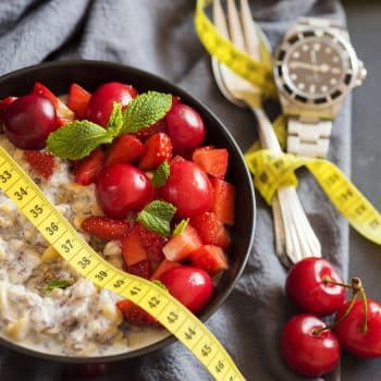 watch, oatmeal, and a tape measure fasting for weight loss