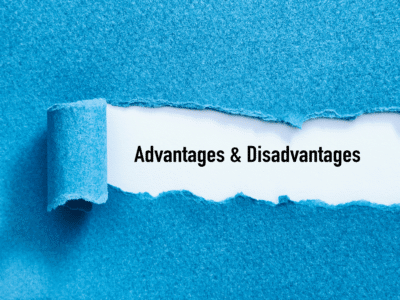 A piece of blue paper is torn away, revealing the words 'Advantages & Disadvantages' underneath in bold black text on a white background. The contrast between the blue and white emphasizes the concept of uncovering or exploring both sides of a topic.