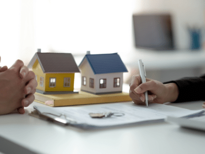 Close-up of a property rental contract signing, showcasing the importance of Certificates of Insurance in rental agreements.